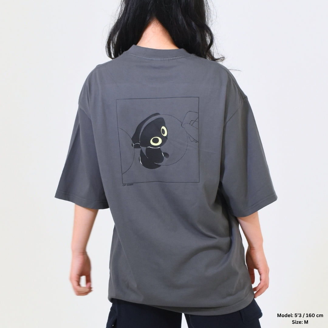 Person wearing a gray t-shirt with a graphic design on the back against a plain background