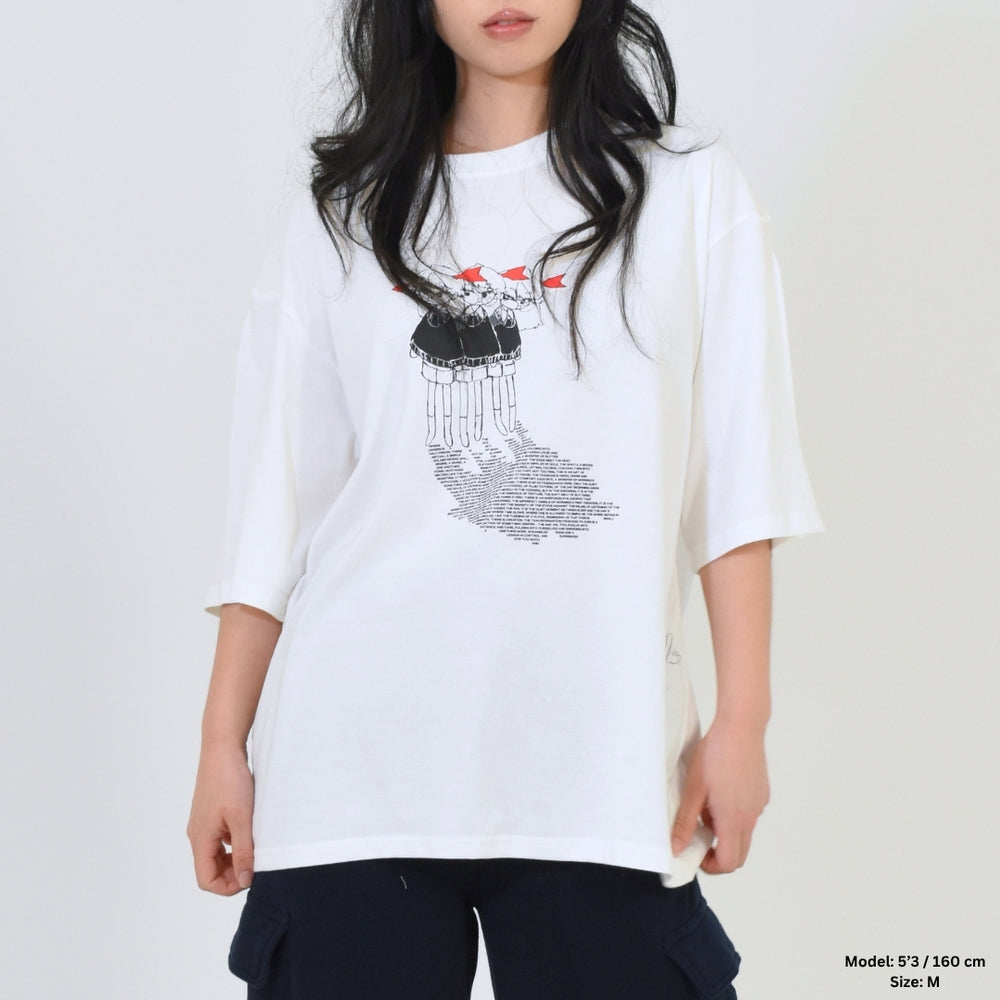 Person wearing a white t-shirt with a graphic design on a plain background