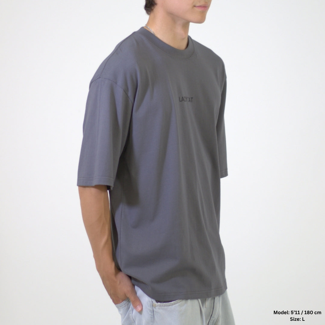 Person wearing a gray t-shirt with a brand logo on a white background