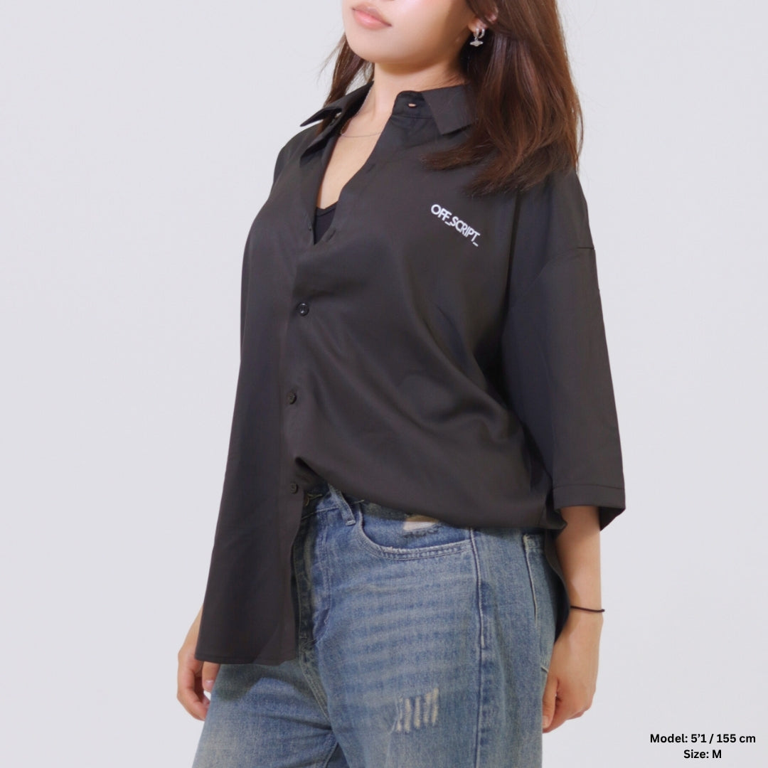 Person wearing a black shirt with 'OFF-SHORE' logo and blue jeans on a plain background