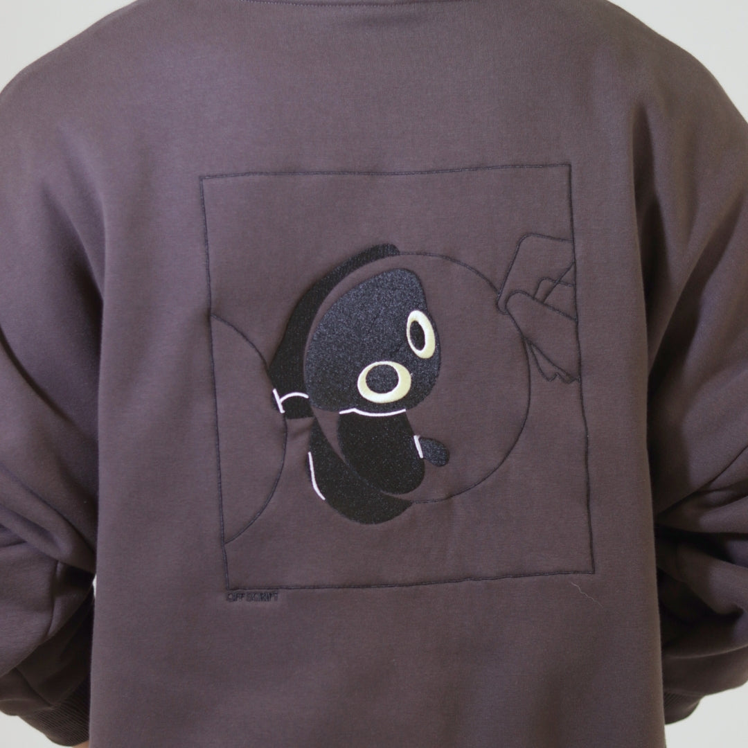 Brown sweatshirt with a cartoon character on the back against a white background