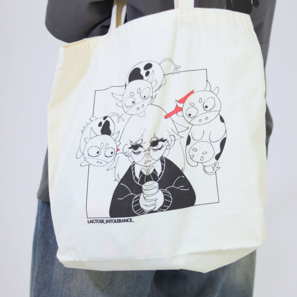 Tote bag with cartoon character design held by a person