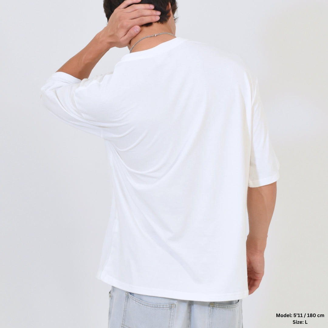 Person wearing a white t-shirt from behind on a plain background