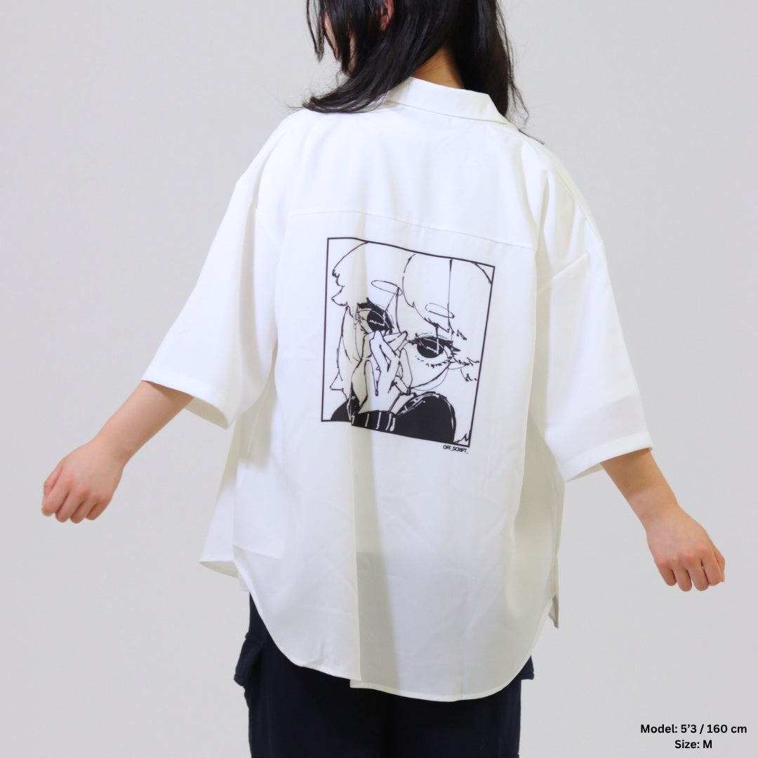 White oversized shirt with black graphic on the back worn by a person against a plain background