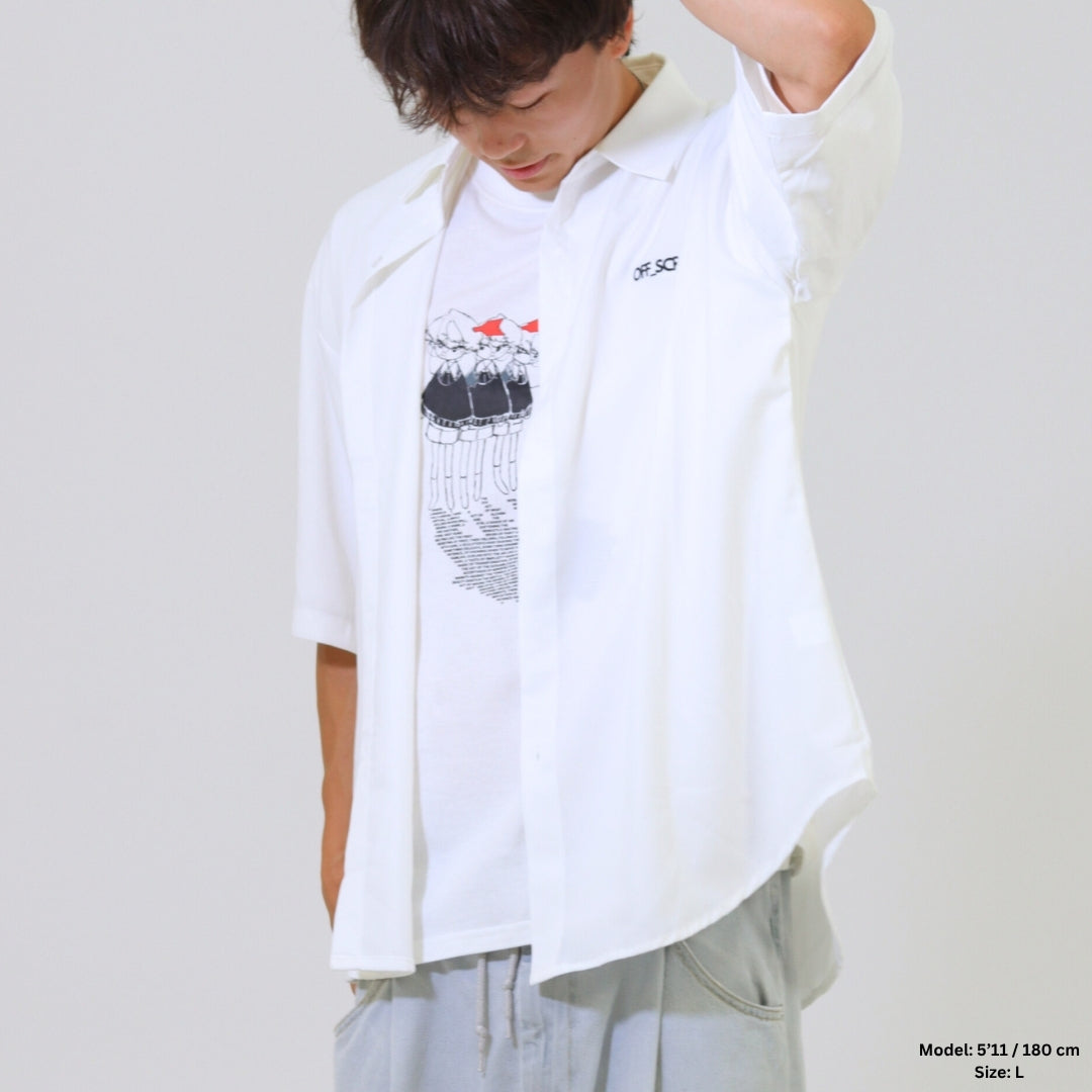 Person wearing a white shirt with a graphic design on a plain background