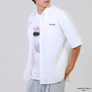 Person wearing a white shirt with graphic design and text on a plain background