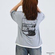 Person wearing a gray t-shirt with 'OFF SCRIPT' graphic on the back, standing against a plain background.