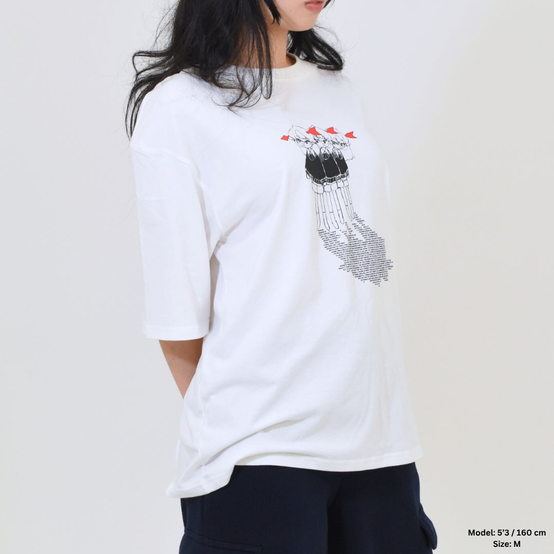 Person wearing a white t-shirt with a graphic design on a plain background