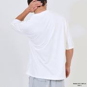 Person wearing a white t-shirt from behind on a plain background